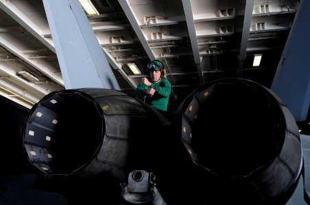 US Navy 101111-N-9132C-022 Aviation Machinist's Mate 3rd Class Kyle Perry, from Center Ossipee, N.H., installs a panel on the aft mount pin of an F