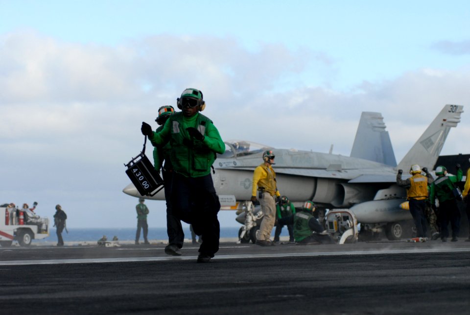 US Navy 101110-N-5684M-074 Aviation Boatswain's Mate (Equipment) Airman Kla Brownell, from Baltimore, Md., runs with a weight board across the bow