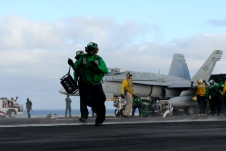 US Navy 101110-N-5684M-074 Aviation Boatswain's Mate (Equipment) Airman Kla Brownell, from Baltimore, Md., runs with a weight board across the bow