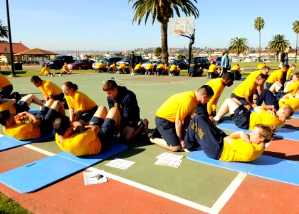 US Navy 101110-N-7214P-031 Sailors assigned to Naval Medical Center San Diego conduct the curl-up portion of the Navy Physical Readiness Test at Ma photo