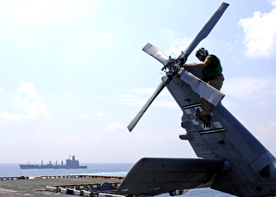 US Navy 101111-N-3154P-236 Naval Air Crewman 1st Class Joseph Ward, assigned to Helicopter Sea Combat Squadron (HSC) 22, examines the tail rotor of