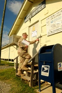 US Navy 101112-N-4936C-058 A Sailor enters the Camp America Post Office at Joint Task Force Guantanamo photo