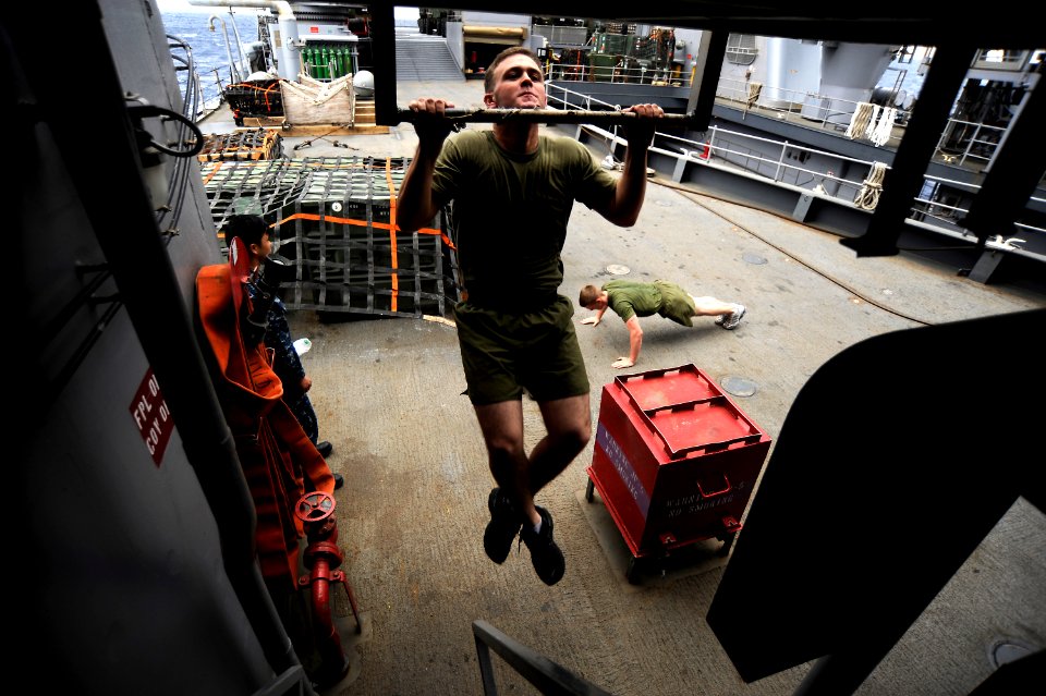 US Navy 101116-N-8335D-097 Lance Cpl. Brendon Wald, assigned to the 31st Marine Expeditionary Unit (31st MEU), does pull-ups aboard the amphibious