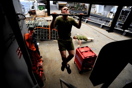 US Navy 101116-N-8335D-097 Lance Cpl. Brendon Wald, assigned to the 31st Marine Expeditionary Unit (31st MEU), does pull-ups aboard the amphibious