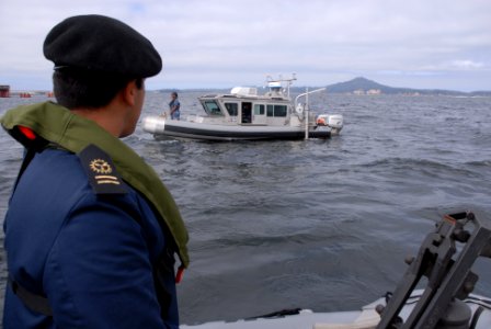 US Navy 101115-N-3535B-065 A Chilean navy hydrographic officer watches Aerographer's Mate 3rd Class Sapheria Myers conduct a navigation survey in t
