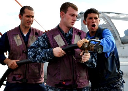 US Navy 101112-N-3620B-009 Aviation Boatswain's Mate (Handling) Airman Serge Soucy, right, relieves Culinary Specialist 3rd Class Christopher Plowd