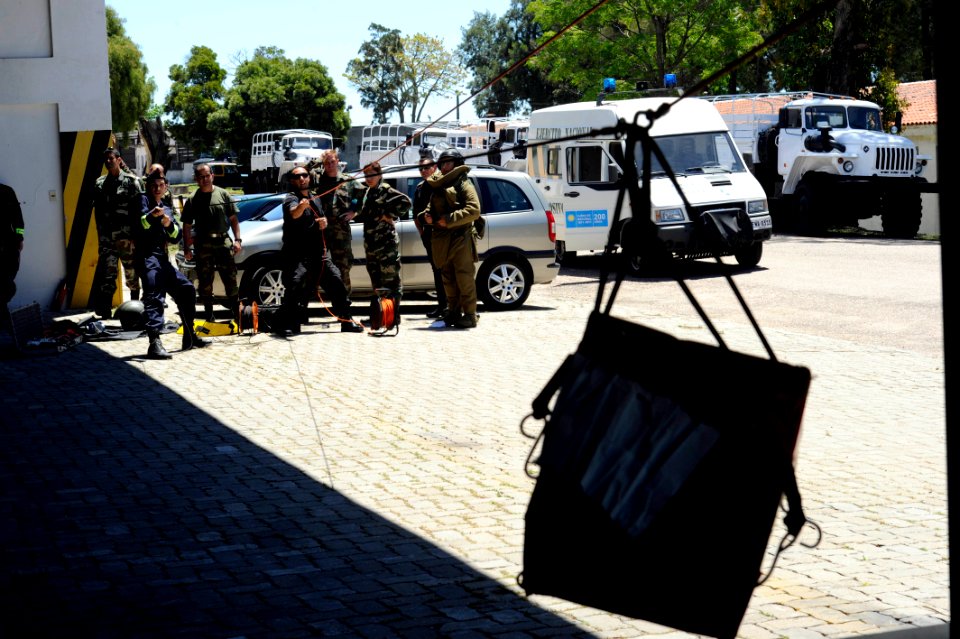 US Navy 101112-N-8546L-196 Uruguayan forces personnel reel in a suspicious package rigged for removal using the hook and line method