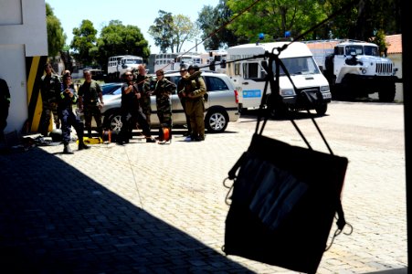 US Navy 101112-N-8546L-196 Uruguayan forces personnel reel in a suspicious package rigged for removal using the hook and line method
