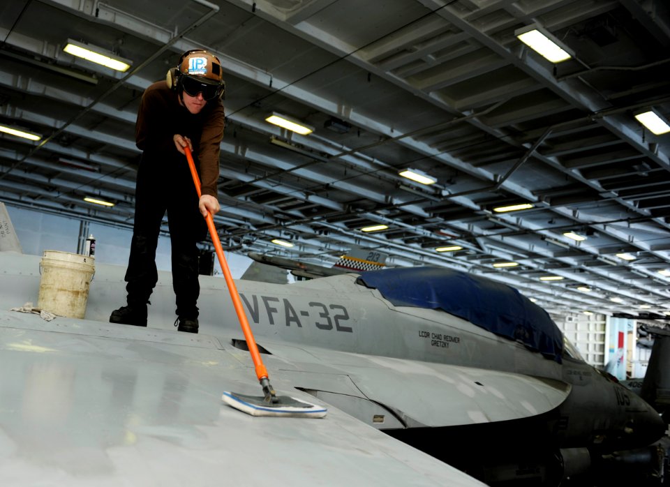 US Navy 101116-N-6427M-029 Airman Bryan Selch, from Crystal Lake, Ill., performs a weekly corrosion prevention cleaning on an F-A-18E Super Hornet