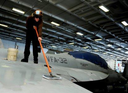 US Navy 101116-N-6427M-029 Airman Bryan Selch, from Crystal Lake, Ill., performs a weekly corrosion prevention cleaning on an F-A-18E Super Hornet