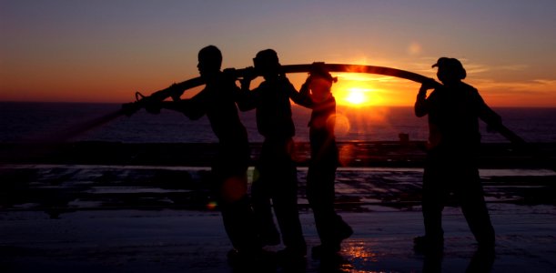 US Navy 101114-N-1240O-266 Sailors hose down the flight deck of the aircraft carrier USS Ronald Reagan (CVN 76) to clean saltwater spray off the sh