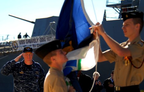US Navy 101112-N-3737T-287 Cmdr. Douglas Kunzman salutes as Ashley High School Navy JROTC cadets raise the Navy ensign photo