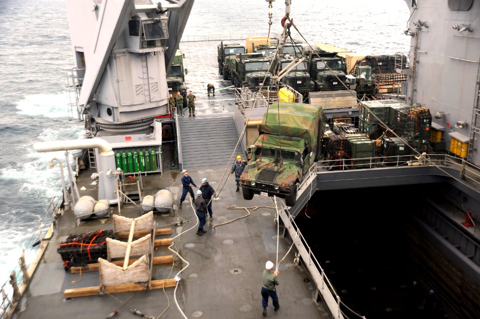 US Navy 101117-N-8335D-113 A Humvee is lifted out of the well deck by the 60-ton crane aboard the amphibious dock landing ship USS Tortuga (LSD 46)