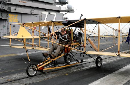 US Navy 101115-N-3885H-265 Bob Coolbaugh pilots a replica of a Curtis Pusher Biplane on the flight deck of the aircraft carrier USS George H.W. Bus