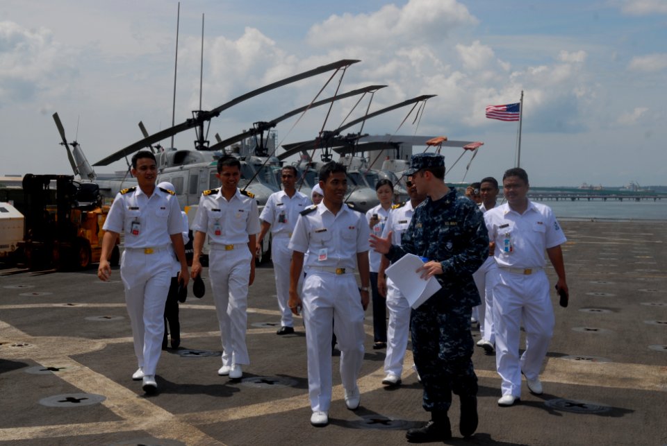 US Navy 101115-N-9706M-216 Ensign Nicholas Ruesch leads Malaysian navy officers on a tour aboard the amphibious transport dock ship USS Dubuque (LP