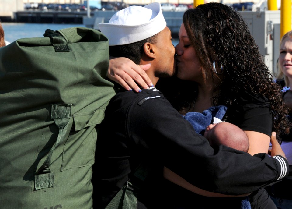 US Navy 101118-N-6125G-106 Aviation Boatswain's Mate (Handling) 3rd Class Bryant Johnston greets his wife and new child at Naval Station Norfolk