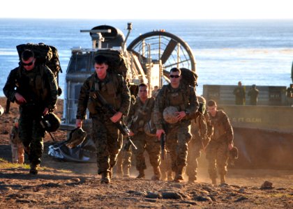 US Navy 101115-N-1722W-172 Marines from the 13th Marine Expeditionary Unit (13th MEU) disembark Landing Craft Air Cushion (LCAC) 76 onto the beach photo
