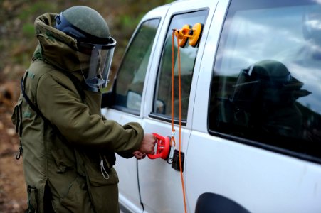 US Navy 101115-N-8546L-183 A Uruguayan army explosive ordnance disposal technician rigs a vehicle door handle to open a vehicle born improvised exp