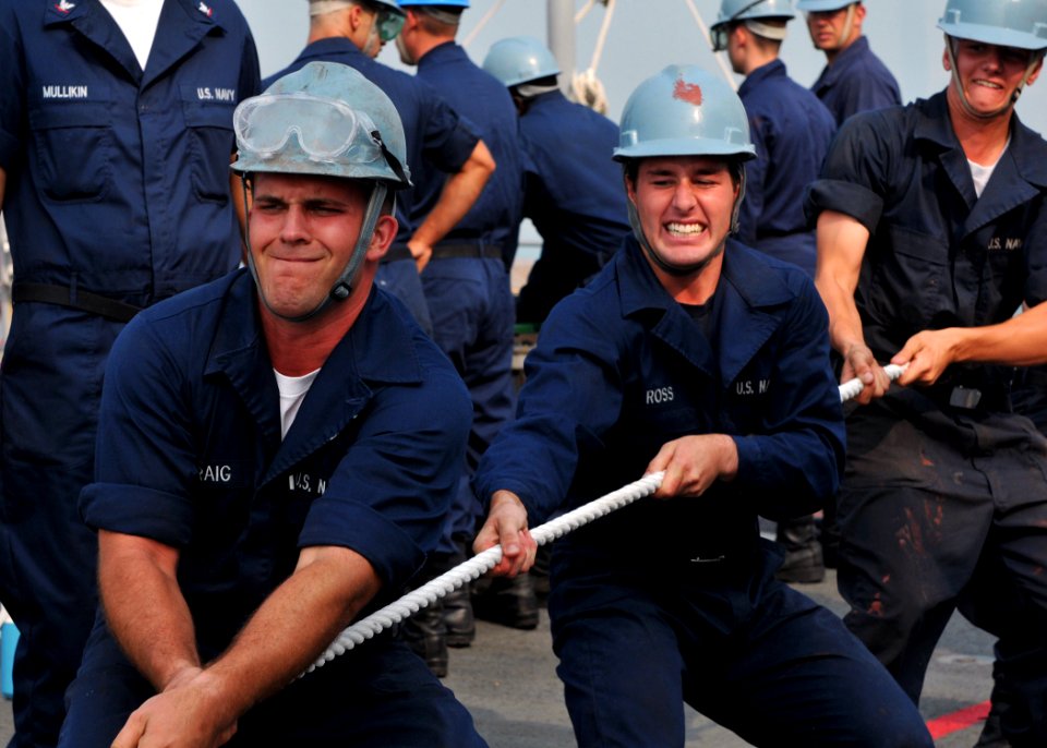 US Navy 101116-N-8113T-142 Seamen Denver Craig, left, and Tyler Ross heave in a mooring line during special sea and anchor detail as the amphibious