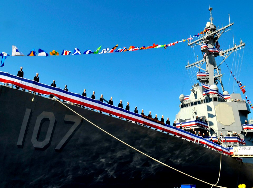 US Navy 101120-N-8273J-093 Crew members of the newest Arleigh Burke-class guided-missile destroyer USS Gravely (DDG 107) man the rails during her c