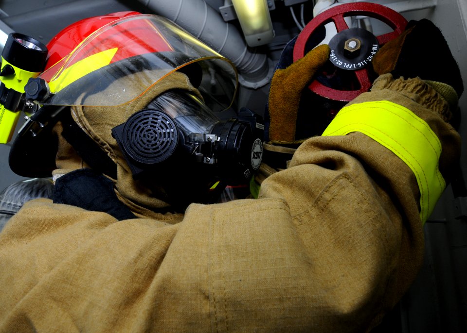 US Navy 101116-N-3154P-347 Logistics Specialist 3rd Class Joemarie Roslin serves as the plugman for an at-sea fire party hose team during a general