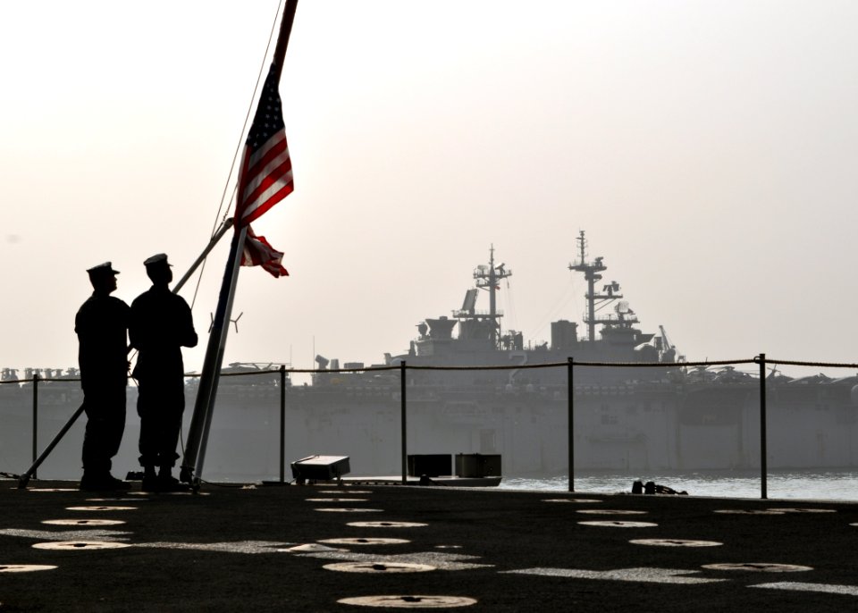US Navy 101116-N-3620B-014 Aviation Boatswain's Mate (Fuel) Airman Adam Pond, left, and Quartermaster Seaman Troy Copeland shift the colors aboard