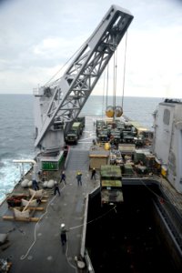 US Navy 101117-N-8335D-227 A Humvee is lifted out of the well deck by the 60-ton crane aboard the amphibious dock landing ship USS Tortuga (LSD 46)
