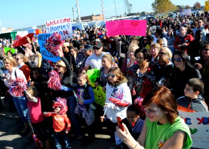 US Navy 101118-N-6125G-118 Family members celebrate the return of the amphibious assault ship USS Iwo Jima (LHD 7) at Naval Station Norfolk. Iwo J