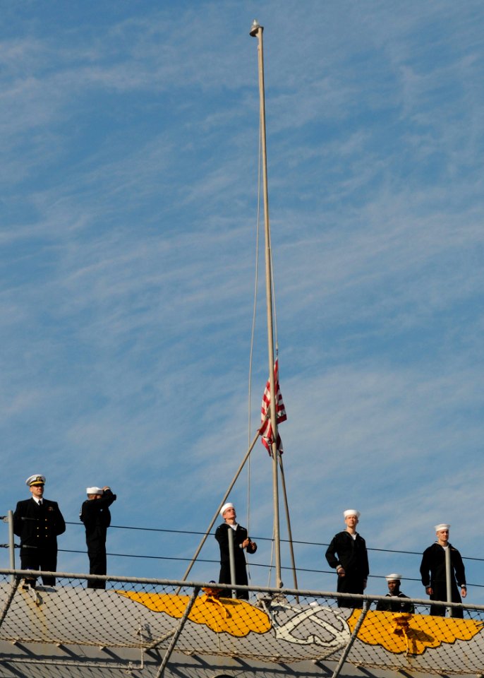 US Navy 101118-N-6125G-061 A Sailor aboard the amphibious assault ship USS Iwo Jima (LHD 7) raises the Union Jack as the ship returns to Naval Stat