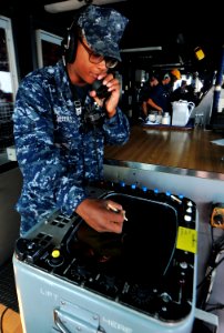 US Navy 101121-N-7948R-096 Operation Specialist Seaman Recruit Billy Weeks talks on a sound powered phone aboard the amphibious dock landing ship U