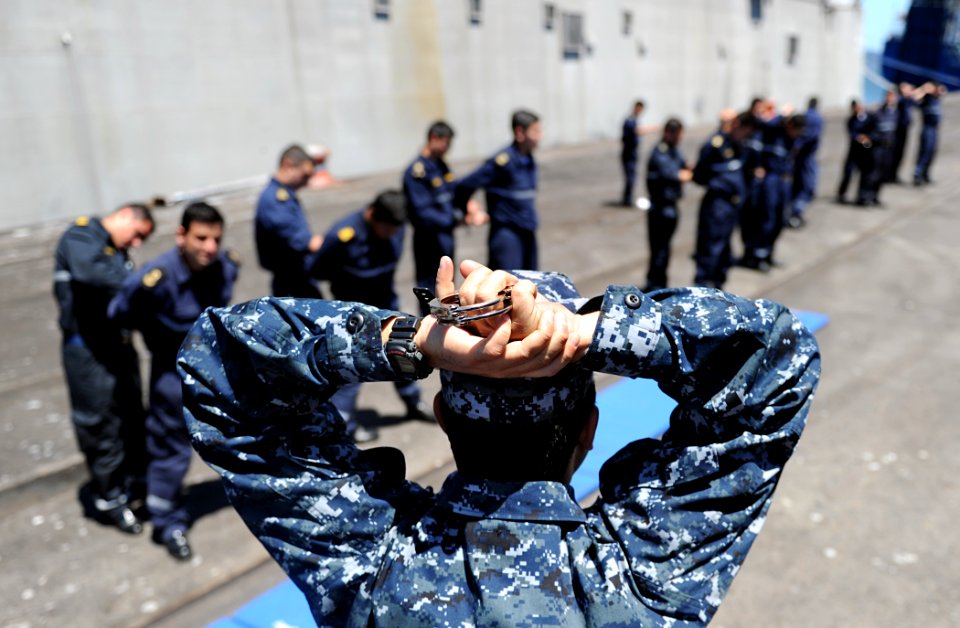 US Navy 101123-N-2984R-200 Master-at-Arms 1st Class Angel Fernandez, foreground, a member of the Naval Criminal Investigative Service Security Trai