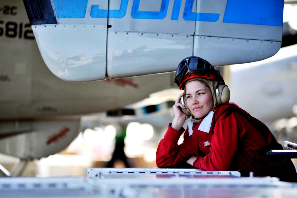 US Navy 101122-N-6003P-008 Aviation Ordnanceman Airman Christina Kelly relaxes a moment during a break in flight operations aboard the aircraft car