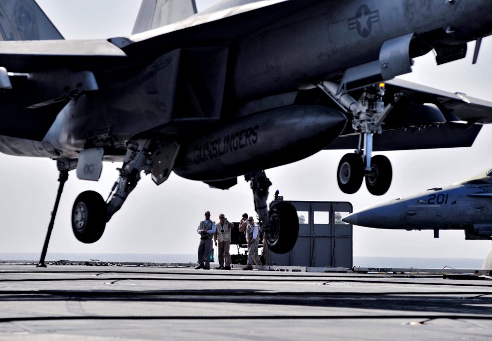 US Navy 101119-N-6003P-030 anding signal officers look on as an F-A-18E Super Hornet assigned to the Gunslingers of Strike Fighter Squadron (VFA) 1