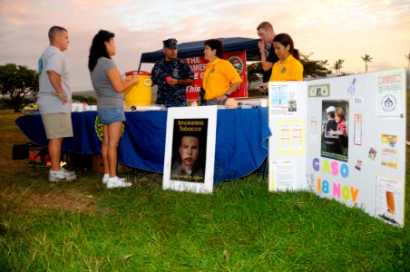 US Navy 101118-N-3560G-001 Tracy Navarrete, center, the Health Promotions Officer at Naval Health Clinic, Hawaii, educates service members on the d