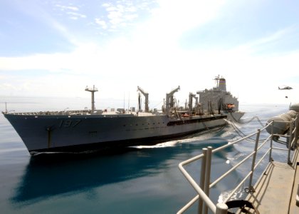 US Navy 101119-N-3729D-178 The Military Sealift Command fleet replenishment oiler USNS Pecos (T-AO 197) transits alongside the amphibious assault s