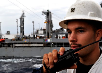 US Navy 101122-N-3620B-035 Boatswain's Mate 1st Class Justin Lacy communicates with the pilothouse aboard the amphibious transport dock ship USS De