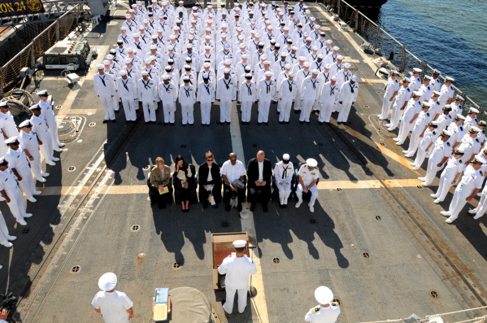 US Navy 101119-N-5812W-004 Sailors aboard the guided-missile destroyer USS Roosevelt (DDG 80) bow their heads in respect to Hospital Corpsman 2nd C