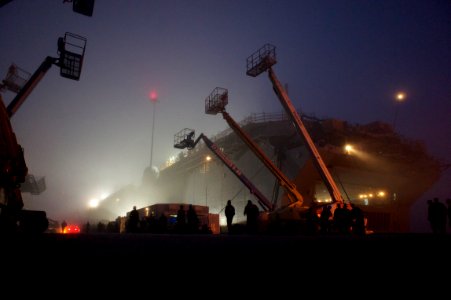 US Navy 101118-N-9643K-785 Sailors assigned to the amphibious assault ship USS Bonhomme Richard (LHD 6) walk through early morning fog to the ship