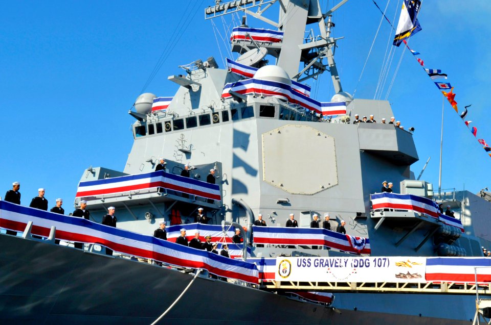 US Navy 101120-N-8273J-097 rew members of the newest Arleigh Burke-class guided-missile destroyer USS Gravely (DDG 107) man the rails during her co