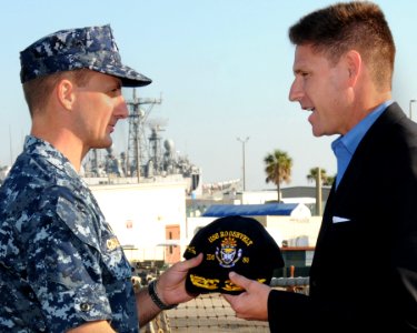 US Navy 101119-N-5812W-001 Cmdr. Robert Chadwick, commanding officer of the guided-missile destroyer USS Roosevelt (DDG 80), welcomes aboard the As