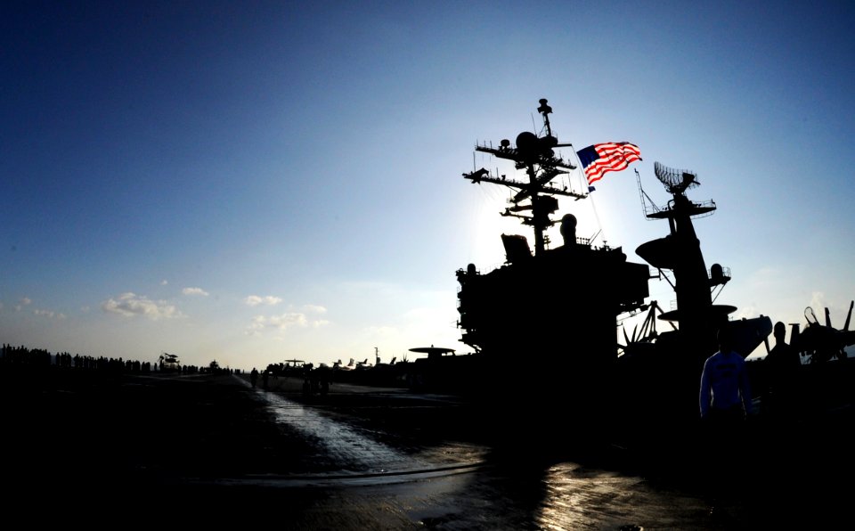 US Navy 101122-N-3793B-524 The battle ensign is flown from the mast of the aircraft carrier USS Harry S. Truman (CVN 75) during a photo exercise wi