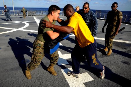 US Navy 101119-N-8335D-428 Hospitalman Ndudic Chukwudozie, center, blinded by oleoresin capsicum (OC) spray, demonstrates his mastery of mechanical
