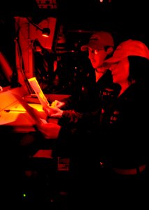 US Navy 101122-N-6003P-517 Lt. Dan Post, officer of the deck, and Lt. j.g. Tracy Culbert, junior officer of the deck, review weather data on the na