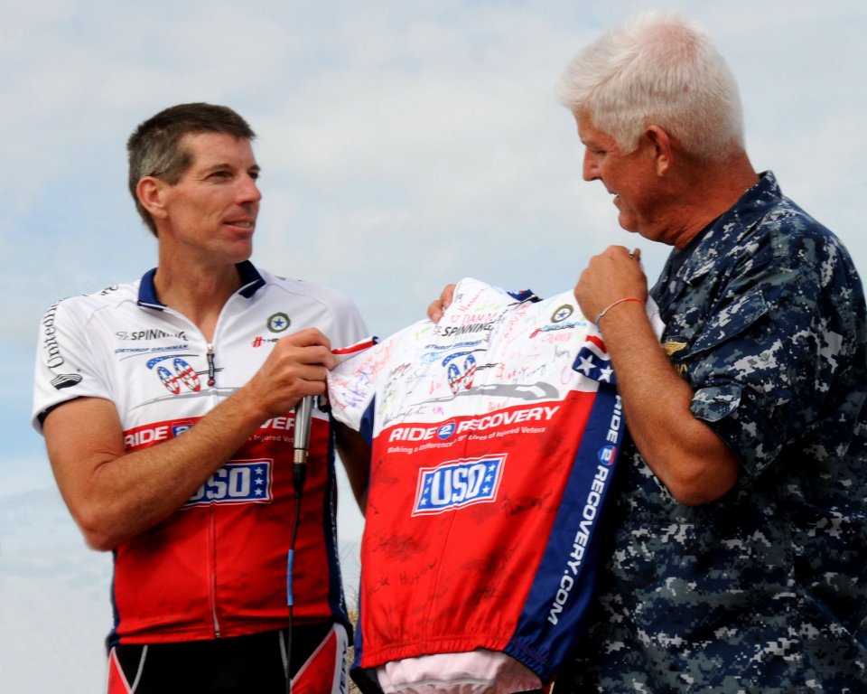 US Navy 101120-N-5812W-001 Jon Wordin, president and founder of Ride 2 Recovery, presents a Jersey signed by all the participants of the 2010 Ride