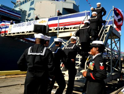 US Navy 101120-N-8273J-080 Crew members of the newest Arleigh Burke-class guided-missile destroyer USS Gravely (DDG 107) man the rails during her c