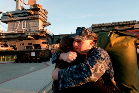 US Navy 101130-N-9123L-042 Information Systems Technician 3rd Class Daniel Strahan says goodbye to his wife as he prepares to board the aircraft ca