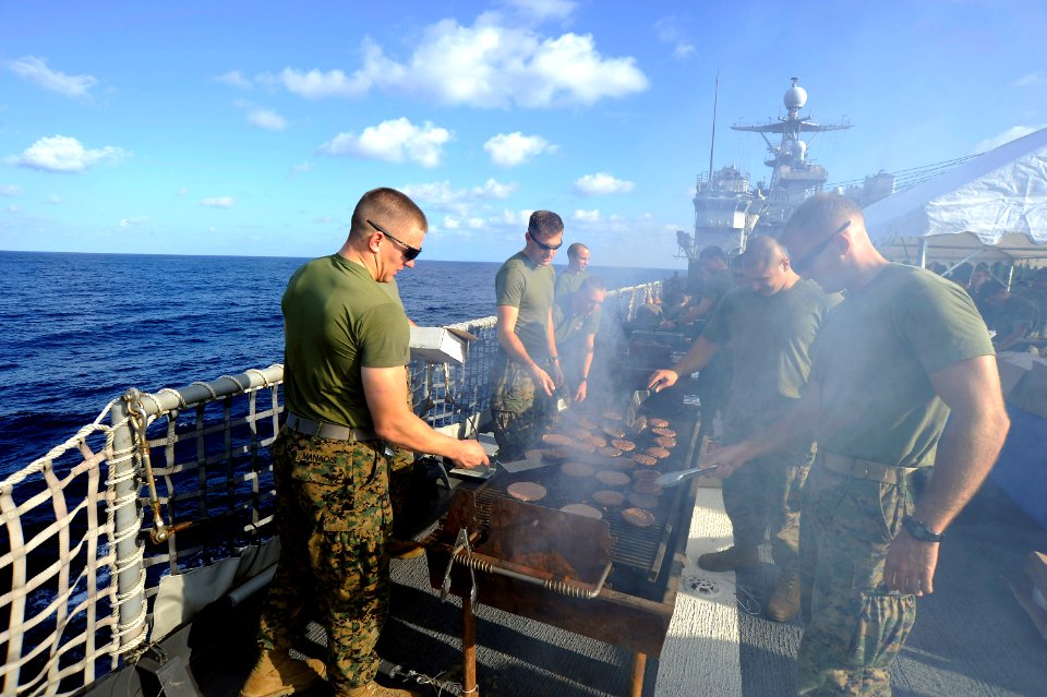 US Navy 101121-N-8335D-151 Officers assigned to the 31st Marine Expeditionary Unit (31st MEU) grill hot dogs during a steel beach picnic