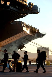 US Navy 101130-N-7981E-396 Sailors board the aircraft carrier USS Carl Vinson (CVN 70) before the ship departs Naval Air Station North Island for a