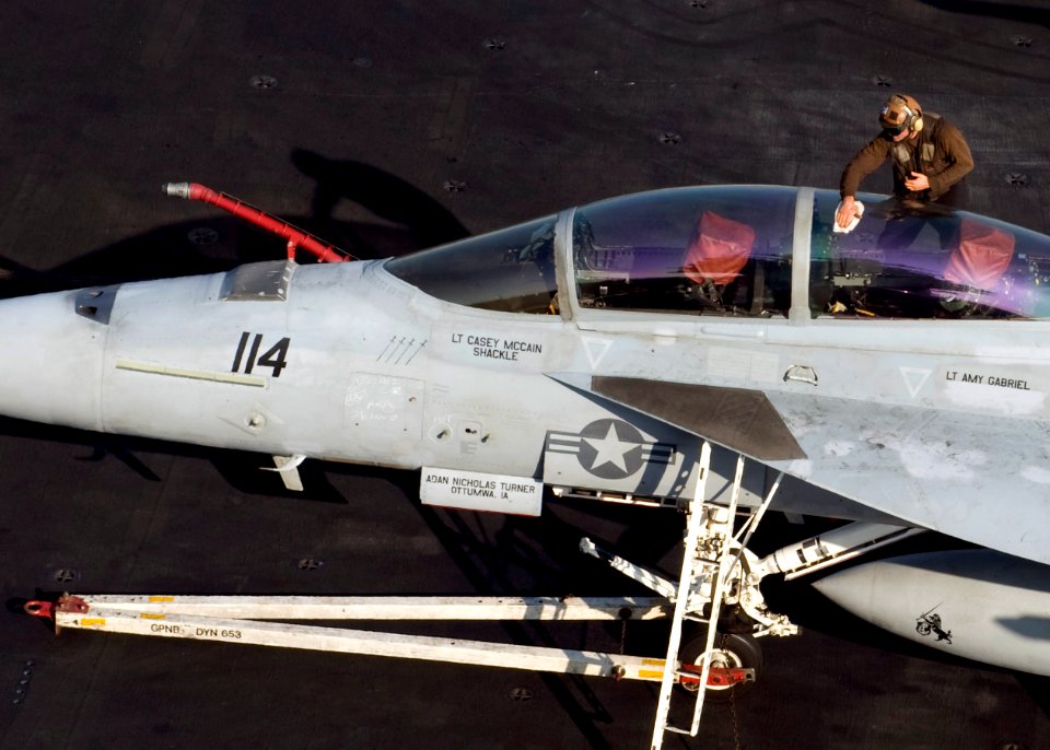 US Navy 101126-N-6427M-280 A plane captain cleans the canopy of an F-A-18 aboard the aircraft carrier USS Harry S. Truman (CVN 75)