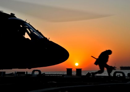 US Navy 101127-N-6499D-205 Logistics Specialist 3rd Class T'ionna Bradley removes chocks from a UH-60 Blackhawk helicopter aboard USS O'Kane (DDG 7